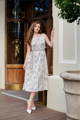 a lady in a printed silk slip dress with belt